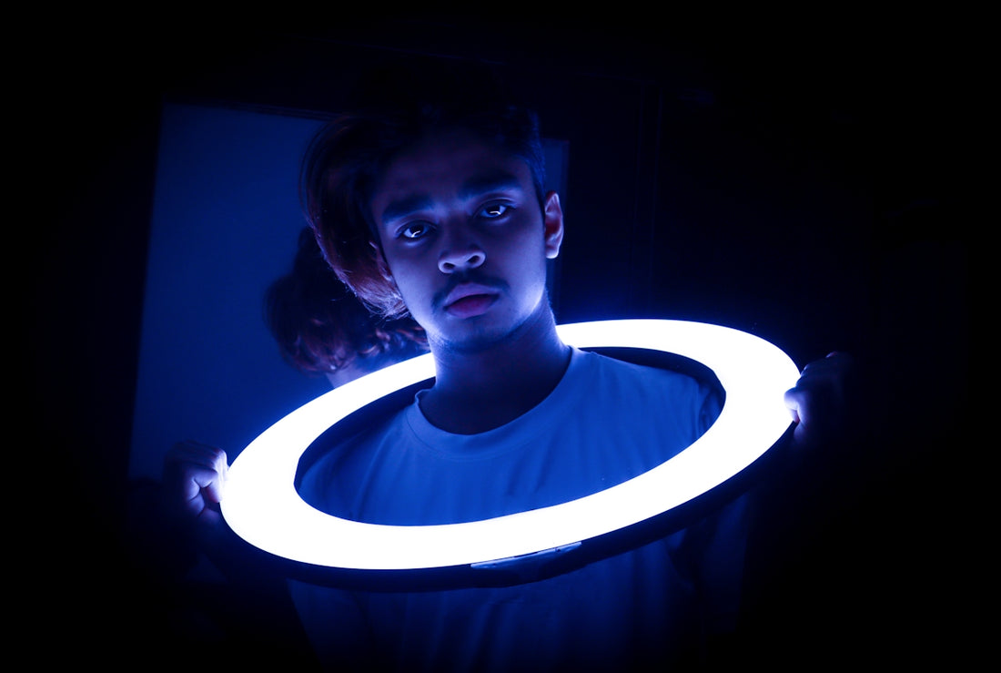 a man holding a glowing object in the dark